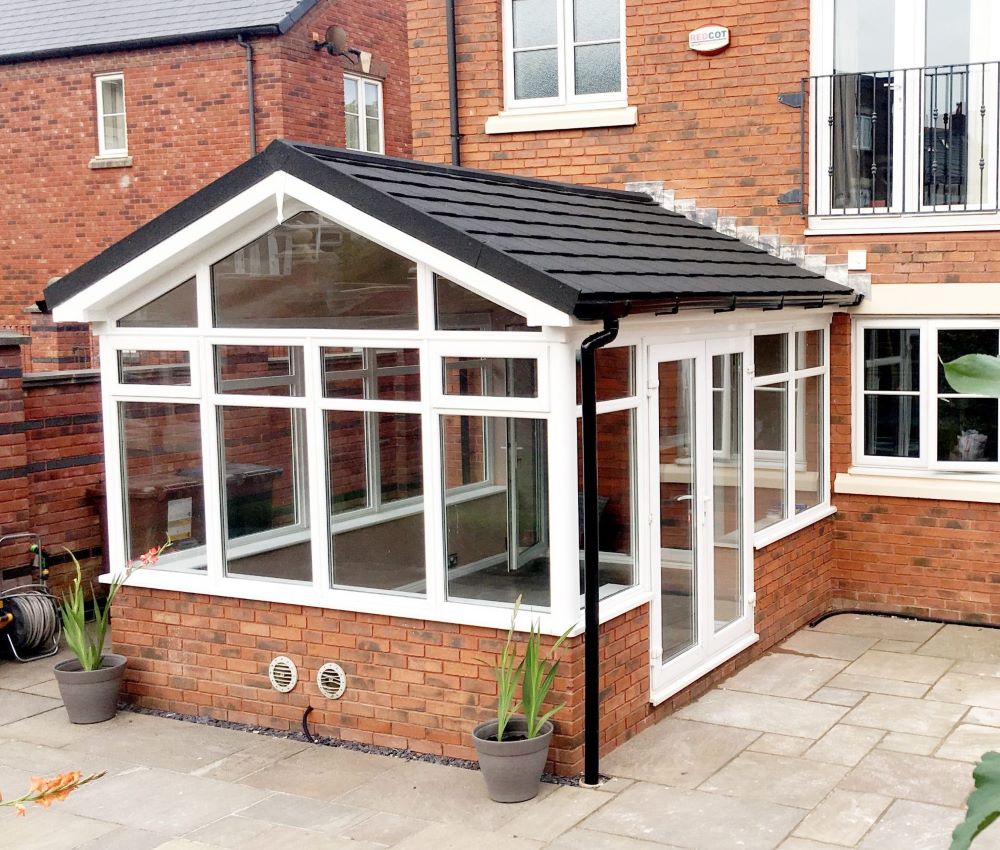 tiled roof white upvc conservatory with white upvc french doors