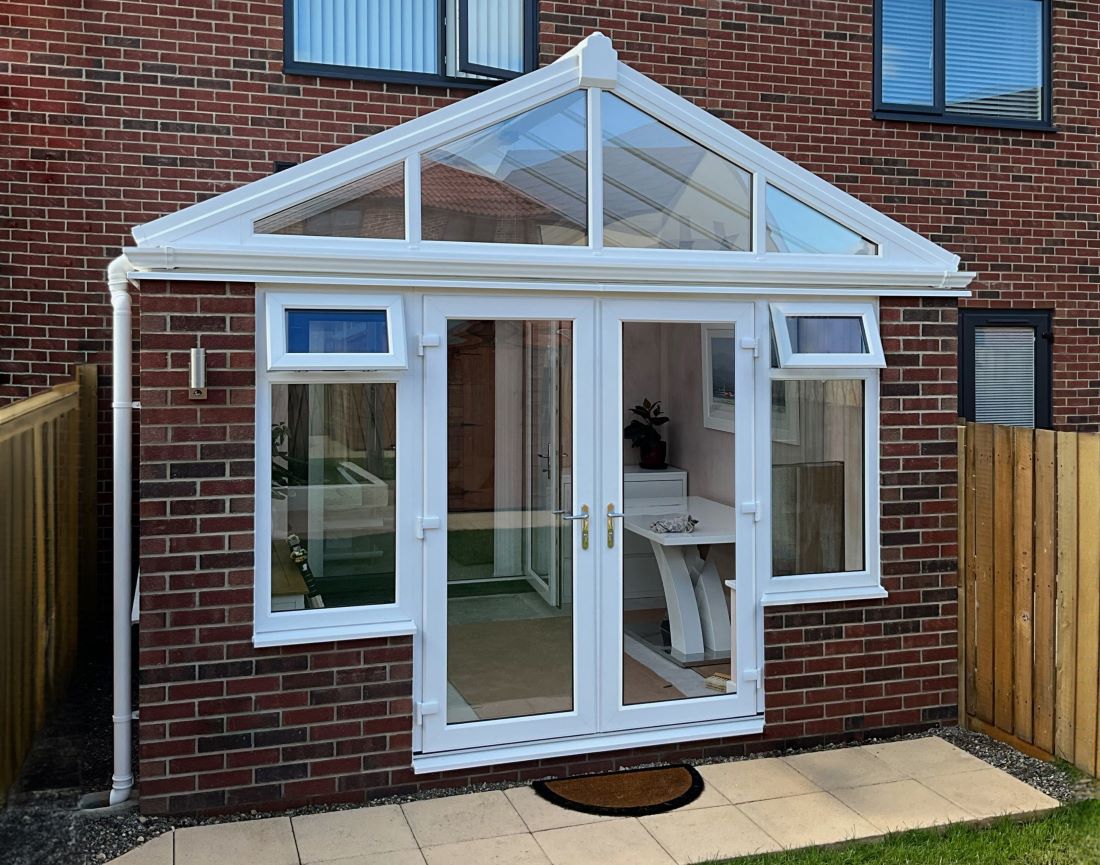 white upvc conservatory with white upvc french doors and windows